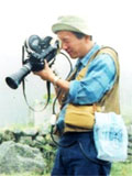 カメラマン 松田重箕。カメラを回して撮影中の様子。